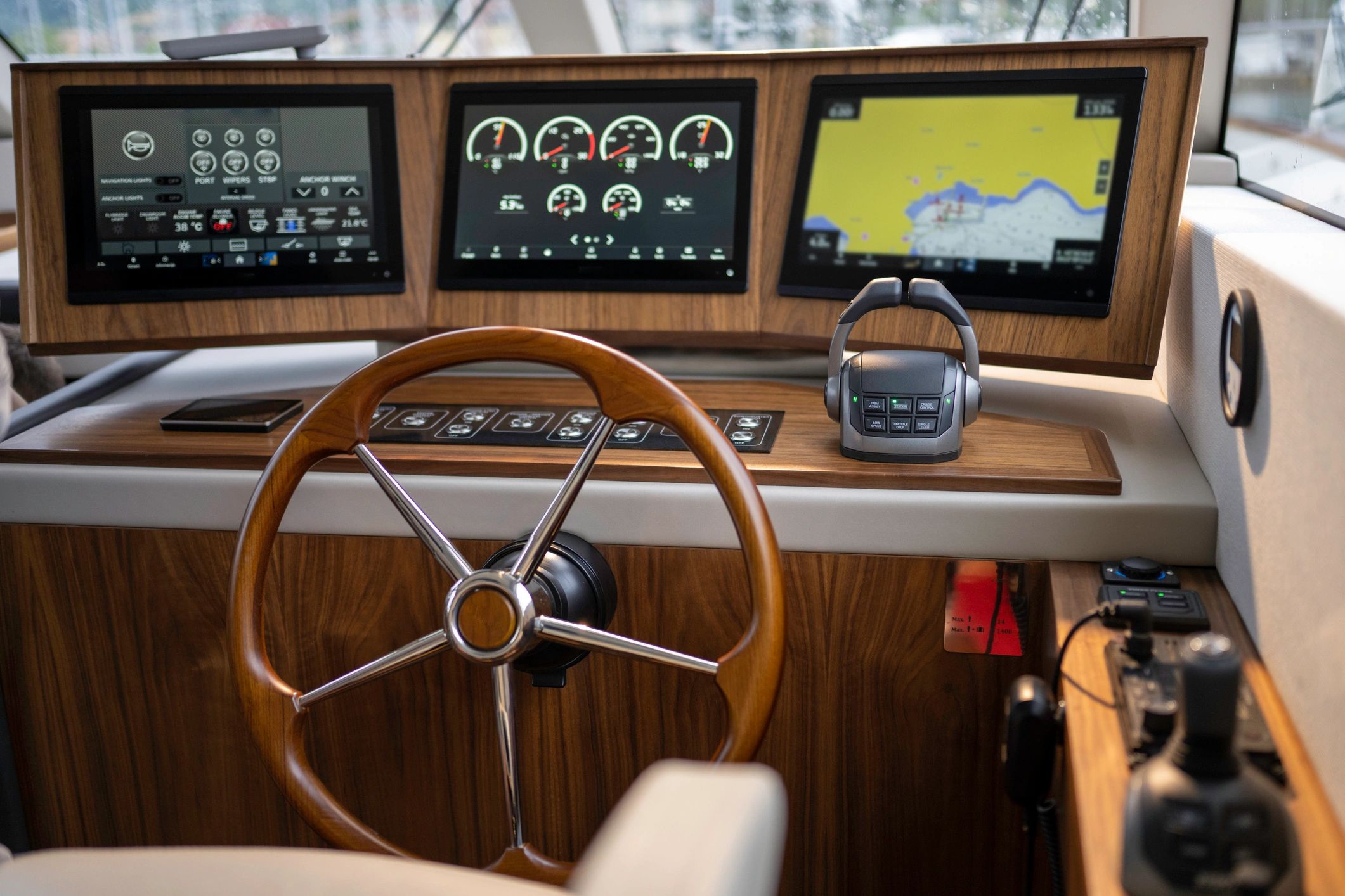 Marine helm controls and wheel on a yacht