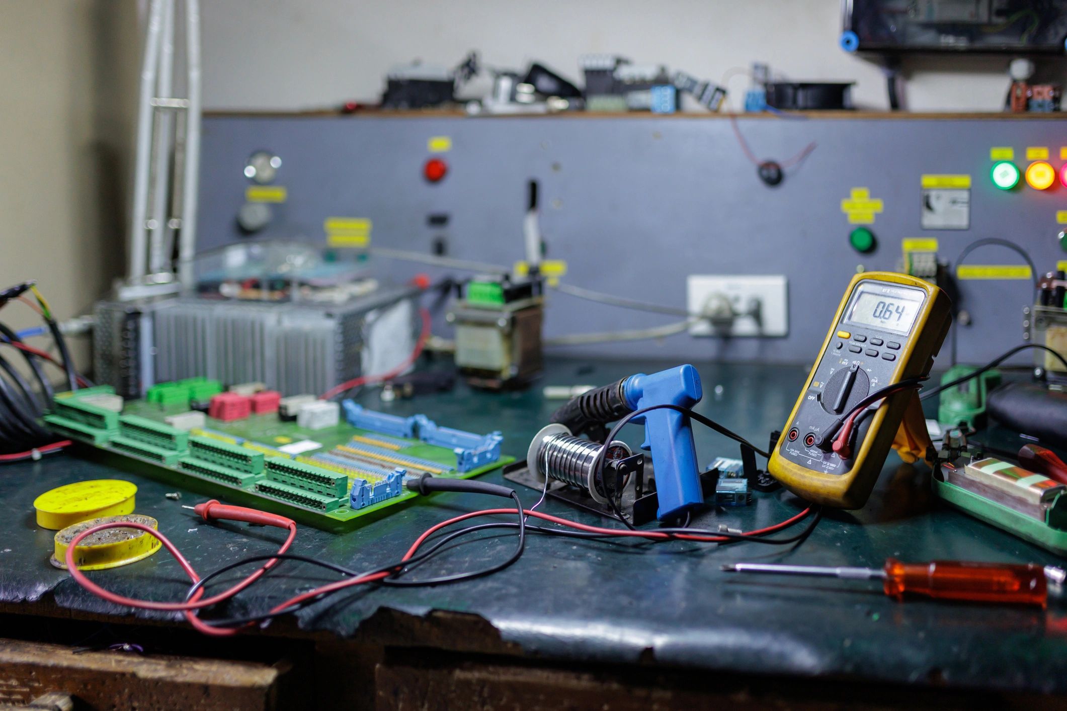Electronics workshop with tools and components on a workbench